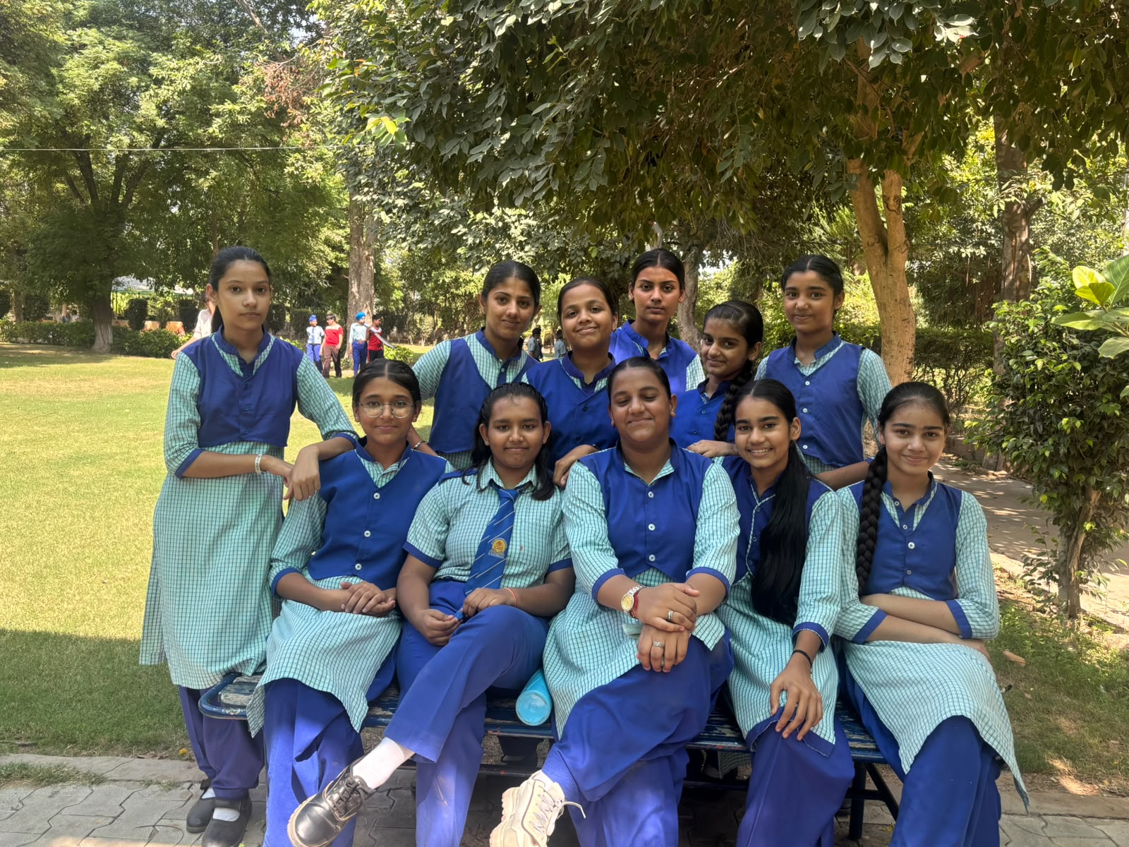 School friends gathered together beneath the trees during the park visit